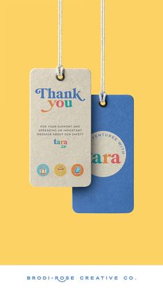 two luggage tags with the words thank you and an image of a blue bag hanging from strings