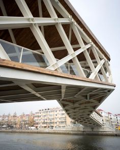 a bridge over water with buildings in the background