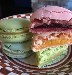 a plate with three different colored pastries on it