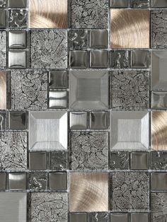 a close up view of a glass and metal mosaic tile wall with silver squares on it