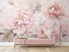 a living room with pink flowers on the wall and a couch in front of it