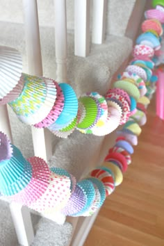 colorful cupcakes are lined up on the stairs