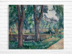 a painting on a brick wall with trees in the foreground and a white fence in the background