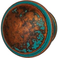 an old metal bowl with blue paint on it