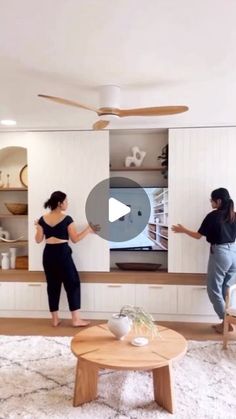 two women standing in front of a flat screen tv