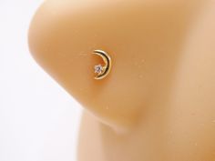 an earring with a diamond in the middle on a mannequin's head