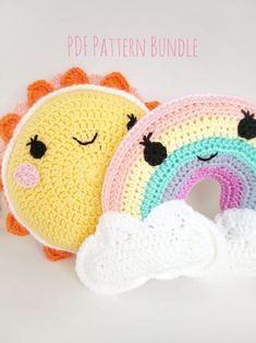 two crocheted pillows with faces on them, one has a rainbow and the other has a cloud