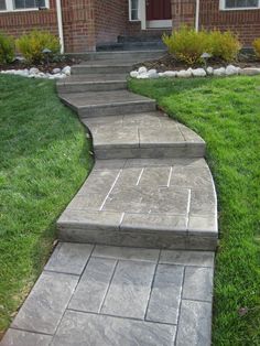 a stone walkway leading to a brick house