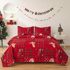 a christmas themed bedroom with red bedding and decorations