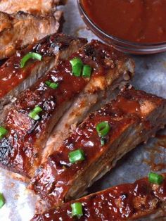 barbecue ribs with sauce and green onions on the side, ready to be served or eaten