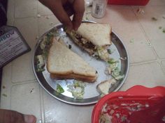 a person is cutting into a sandwich on a plate