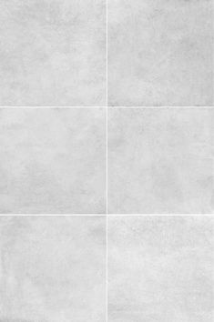 a white tile wall with four squares in it