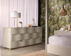 a bedroom scene with focus on the dresser and bed