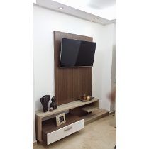 a flat screen tv sitting on top of a wooden entertainment center