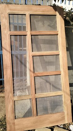 an old wooden window sitting on the side of a building