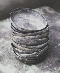 a stack of bowls sitting on top of a stone slab