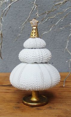 a white knitted christmas tree with a gold crown on top