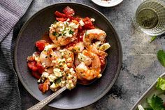 a plate with shrimp, tomatoes and feta cheese