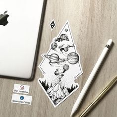 an apple computer sitting on top of a desk next to a pen and sticker