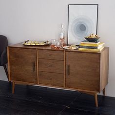 a wooden sideboard with two plates on it