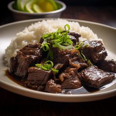 a white plate topped with beef and rice