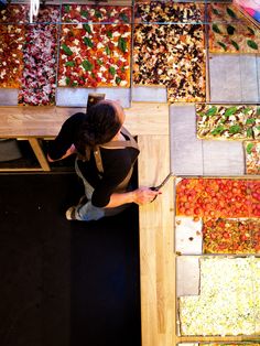 a person standing in front of a display of food