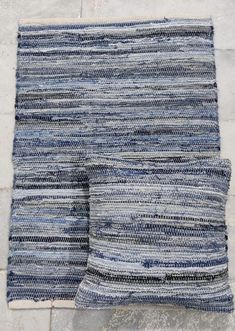 two blue and white rugs sitting on top of each other