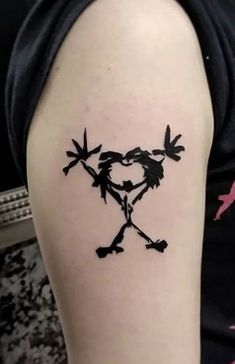 a person with a tattoo on their arm that has the shape of a heart and two arrows