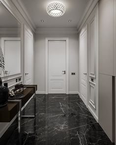 an empty hallway with marble flooring and white walls