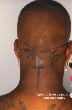 the back of a man's head with tattoos on it