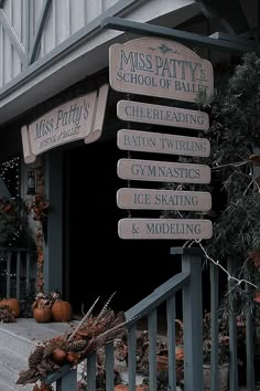 a bunch of signs that are on the side of a building in front of some pumpkins