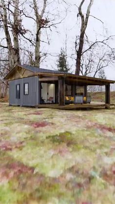 a small house sitting in the middle of a field next to some trees and grass