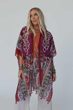 You'll add a stunning addition to your boho wardrobe with our Tabitha Floral Kimono, sure to become a cherished piece in your collection, adding a touch of bohemian glamour to every occasion! You'll love layering with this eye-catching kimono becasue it features: Lightweight, woven, slightly sheer fabric with a so pretty print throughout Relaxed and loose kimono silhouette Classic open front closure Loose kimono style sleeves and side slits created by single side seams So cute tassel details alo Festive Bohemian Kaftan With Floral Print, Bohemian Printed Kimono For Beach Cover-up, Red One-size Kimono For Festivals, Bohemian Kimono With Boho Print For Beach Cover-up, Bohemian Festive Kaftan, Festive Floral Print Kimono, Boho Print Kimono For Beach In Fall, Bohemian Floral Print Kimono, Fall Beach Kimono With Boho Print