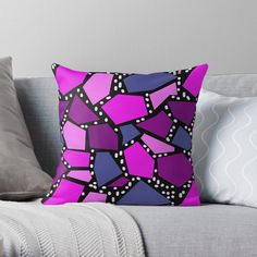 a purple and black abstract design on a couch throw pillow with polka dot dots in the middle