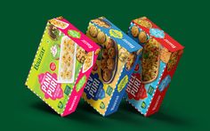 three boxes of cereal on a green background