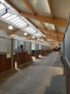 an empty horse barn with stalls and lights