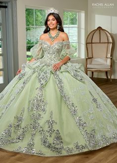 Light up the room in this beaded applique long off shoulder puff sleeve dress with A-line skirt by Rachel Allan RQ3128. Discover elegance and grace in this tulle ballgown. This romantic ballgown radiates with sophistication and is sure to leave a lasting impression. The off-the-shoulder neckline is hand beaded with applique and fringed detailing, adding a regal look to the entire silhouette. Detachable tulle sleeves provide a subtle vintage touch and a lace-up back offers the ultimate fit. As yo Quinceanera Dresses Sleeves, Quinceanera Dresses With Sleeves, Mint Green Quinceanera, Mint Green Quinceanera Dresses, Off Shoulder Puff Sleeve Dress, Detachable Tulle Sleeves, Quinceanera Dresses Off The Shoulder, Green Quinceanera Dress, Green Quinceanera