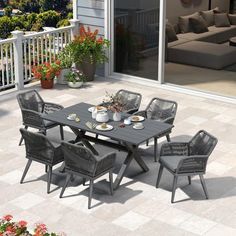 an outdoor table and chairs on a patio