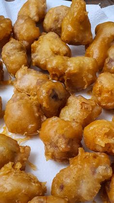 some fried food is sitting on a white table top and it looks like they are ready to be eaten