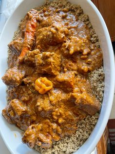 a white bowl filled with meat and rice