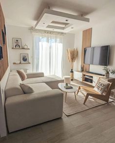 a living room filled with furniture and a flat screen tv on top of a wall