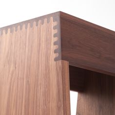 a close up view of a wooden table with holes in the top and bottom section