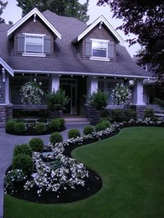 a large house with landscaping in front of it