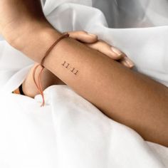 a woman's arm with the word hope tattooed on it, sitting in bed