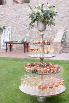 a three tiered tray with champagne glasses on it