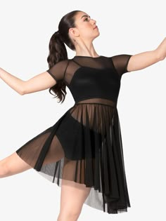 a woman in a black leotard with her arms outstretched