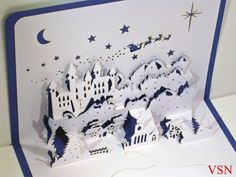 a pop up card with an image of a castle in the sky and stars on it