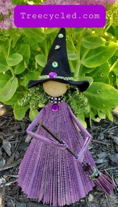 a purple scarecrow with green eyes and a black hat