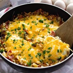 an egg casserole with cheese and bacon in a skillet on a table