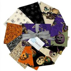 a bunch of different halloween themed items on top of each other with a ribbon around it